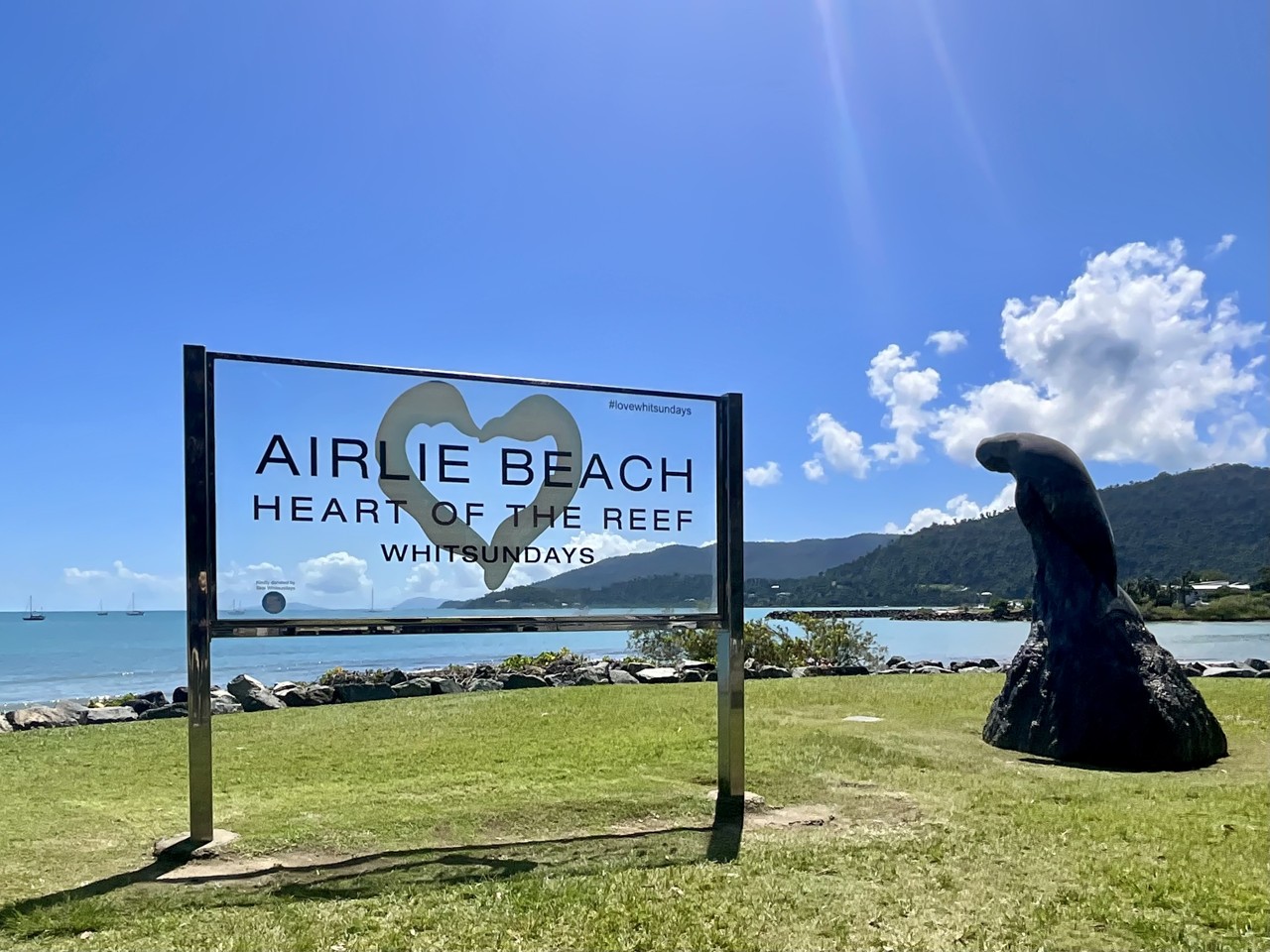 Airlie Beach, QLD, Sign by the waterfront with bay view