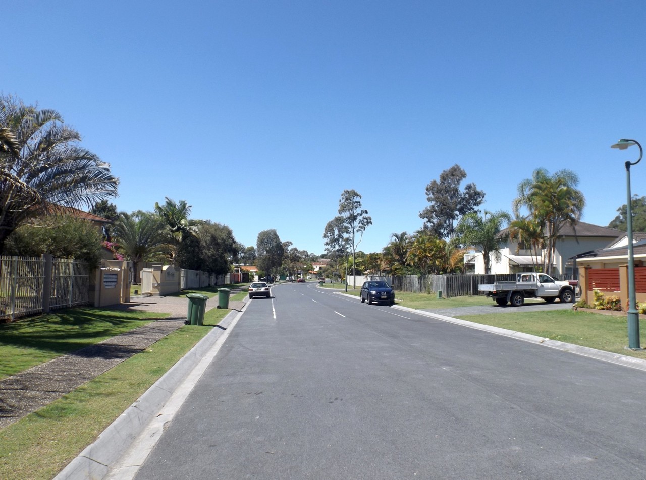 Arundel, QLD, Residential street lined with houses and trees