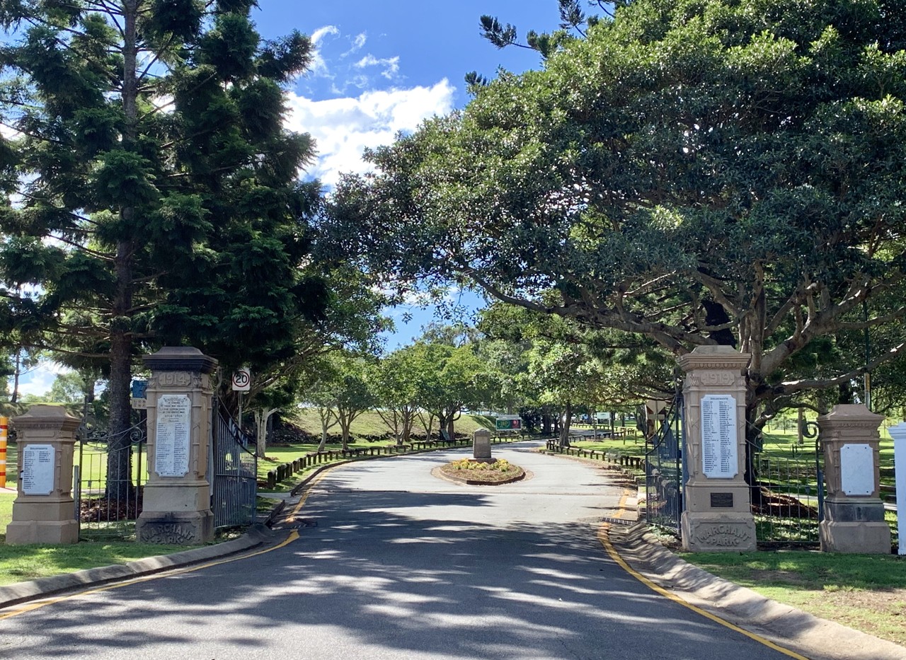 Aspley, QLD, Entrance road flanked by trees and stone pillars