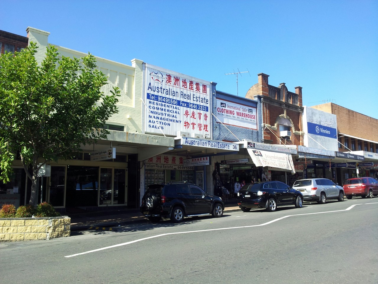Auburn, NSW, Federation shopfronts with parked cars on street