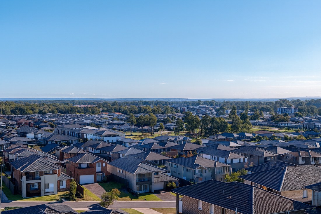 Austral, NSW, Residential rooftops stretching toward distant trees