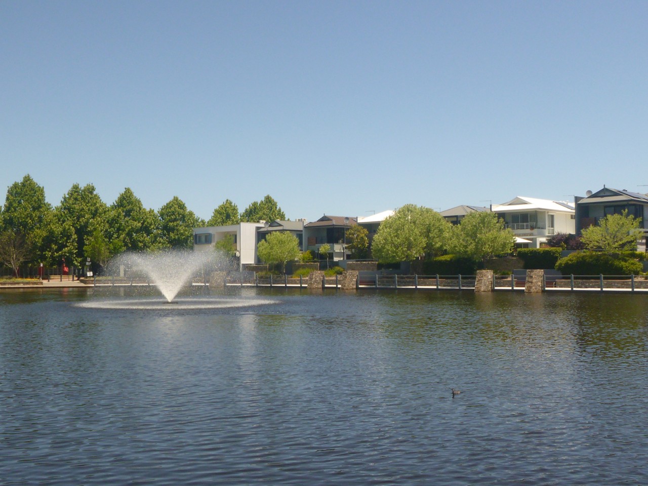 Aveley, WA — Fountain in a suburban pond near houses