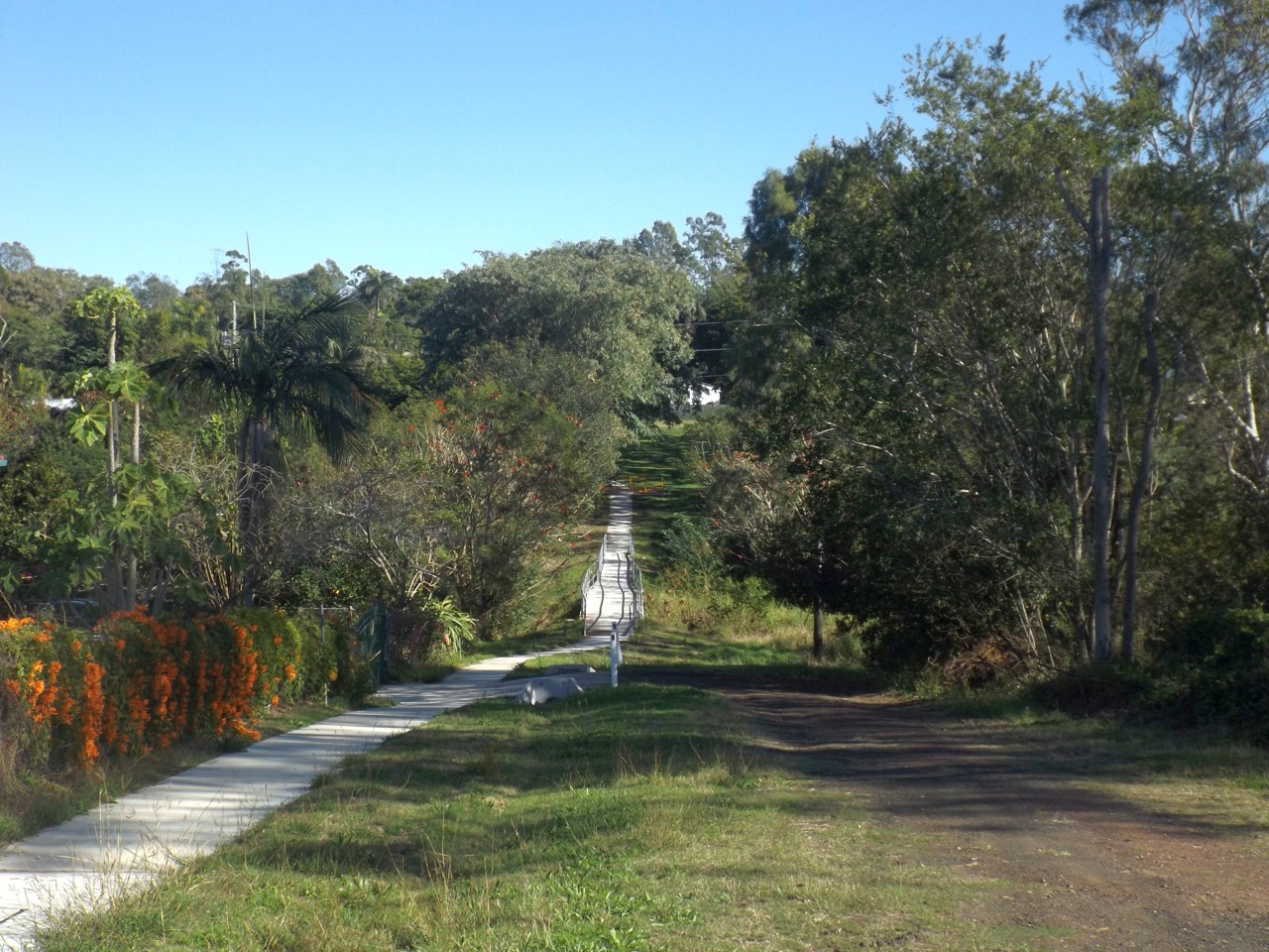 Bellbird Park, QLD, Dirt path and trees alongside a paved walkway