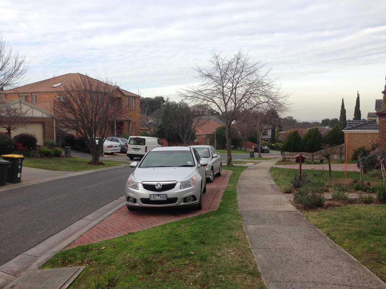Burwood East, VIC, Residential street with parked cars and houses