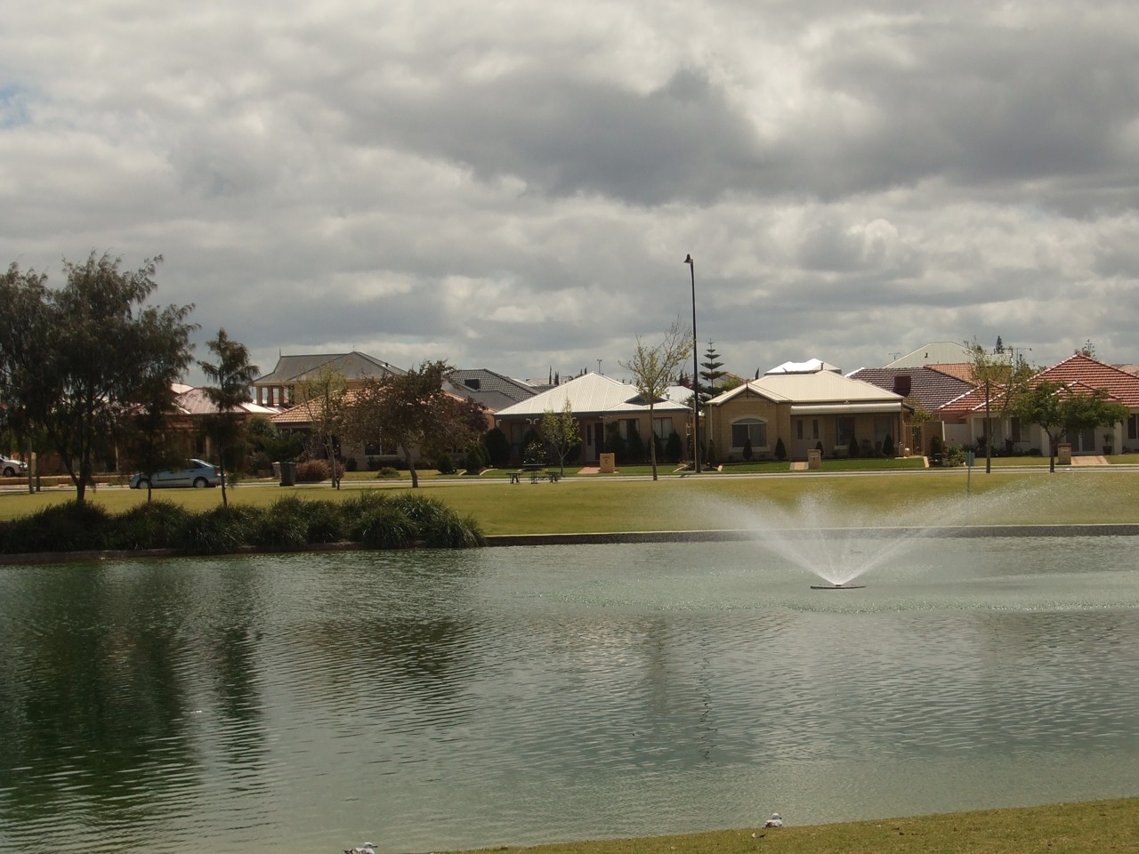 Butler, WA, Residential houses behind a small lake with fountain