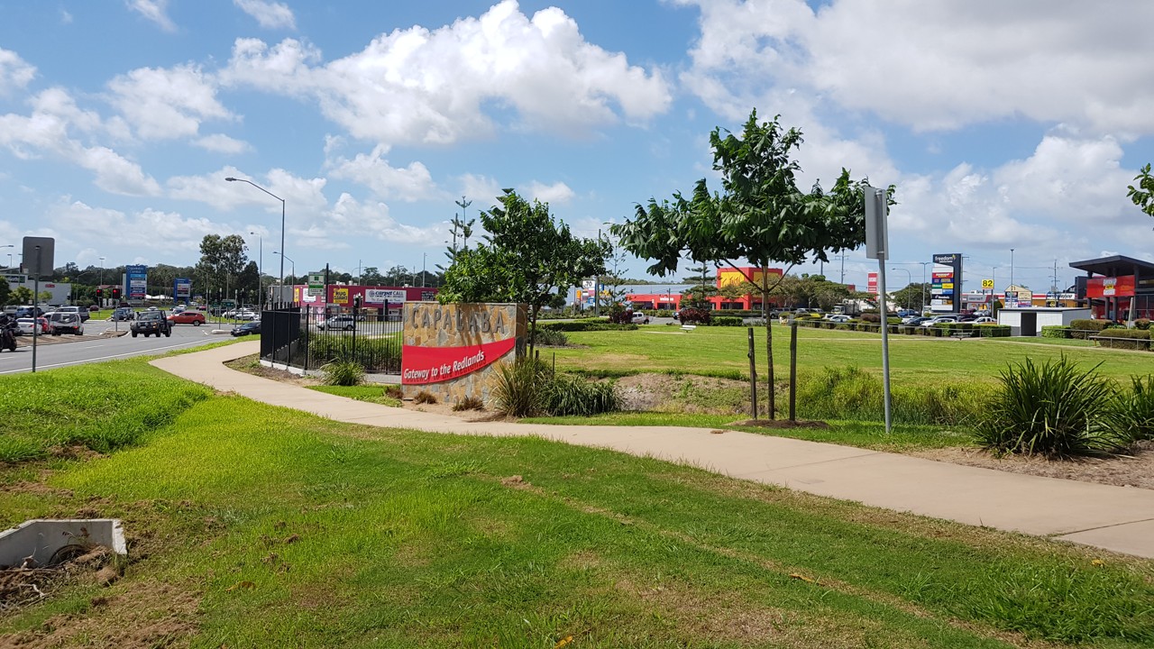 Capalaba, QLD, Welcome sign near commercial area with trees