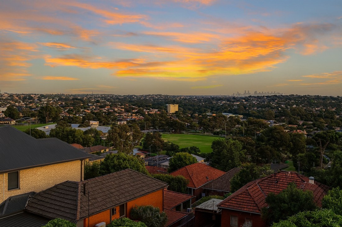 Chadstone, VIC, Suburban rooftops with distant city skyline view