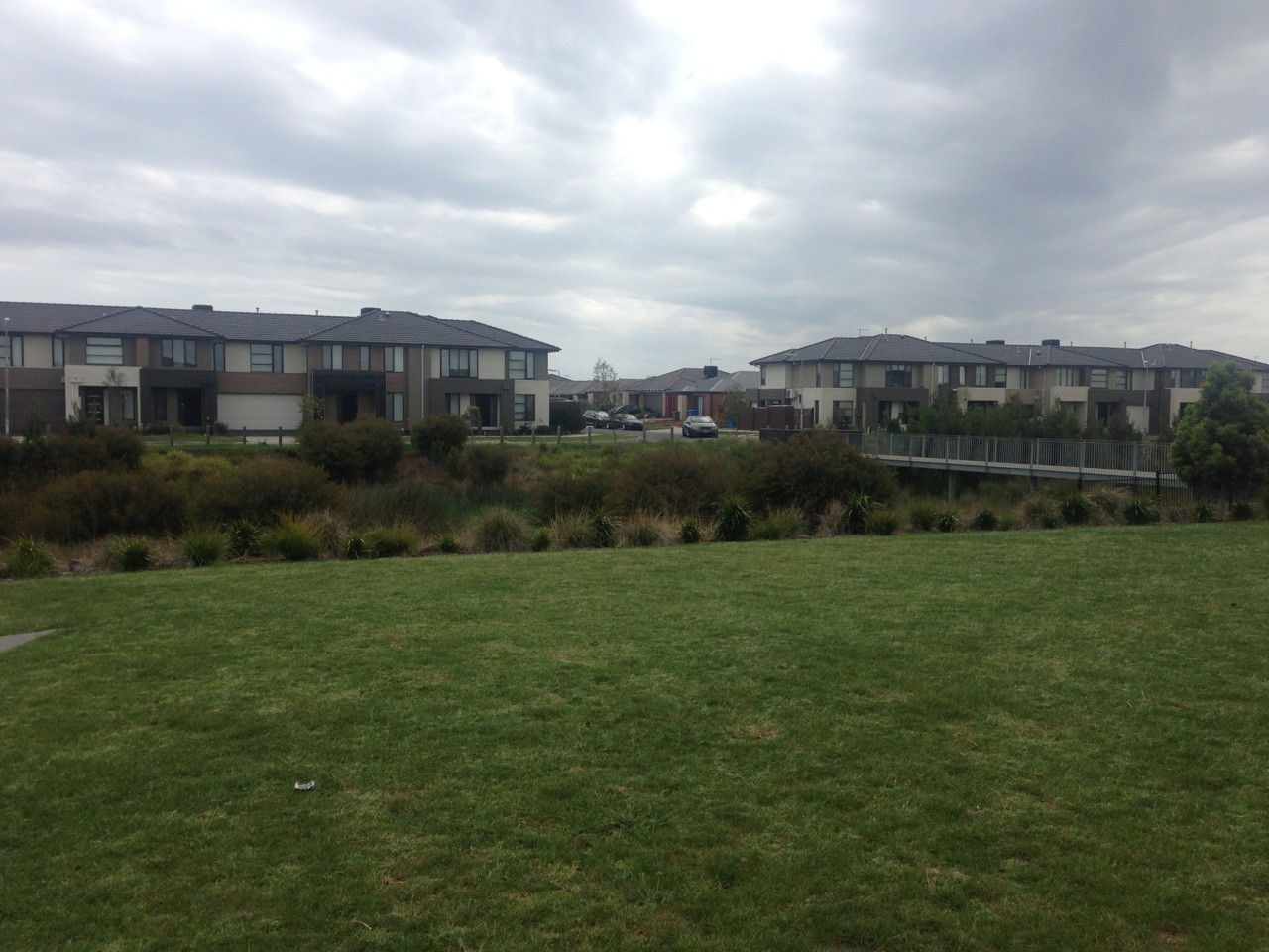 Clyde North, VIC — Modern suburban houses behind a grass area