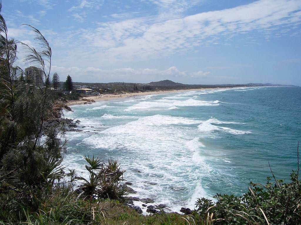 Coolum Beach, QLD, Surf beach with waves and rocky headland