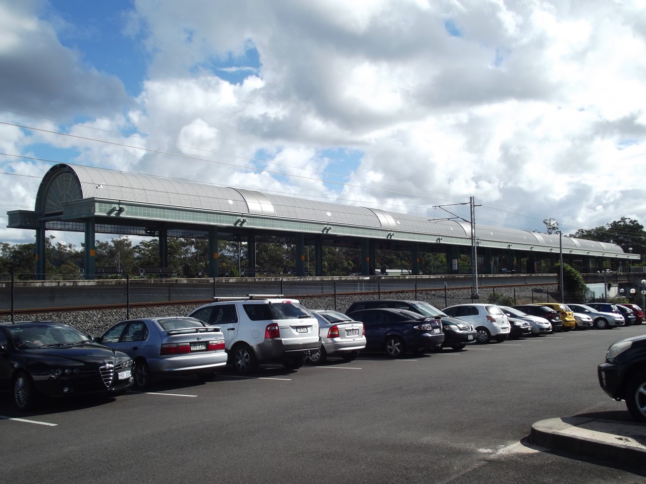 Coomera, QLD, Train station platform with parking area