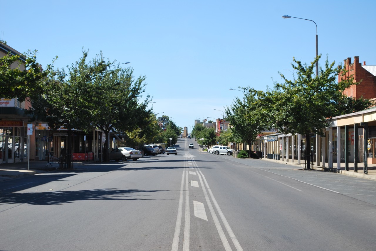 Corowa, NSW, Shady street with shops and parked cars