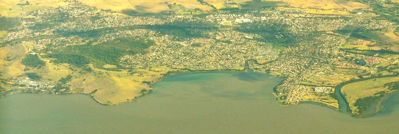 Dapto, NSW, Aerial view of a town near a lake