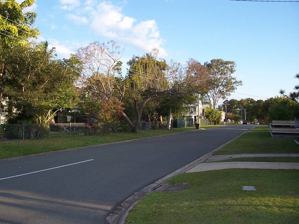 Deception Bay, QLD, Residential street lined with trees and houses