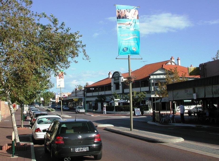 East Victoria Park, WA, Street with parked cars and shopfronts