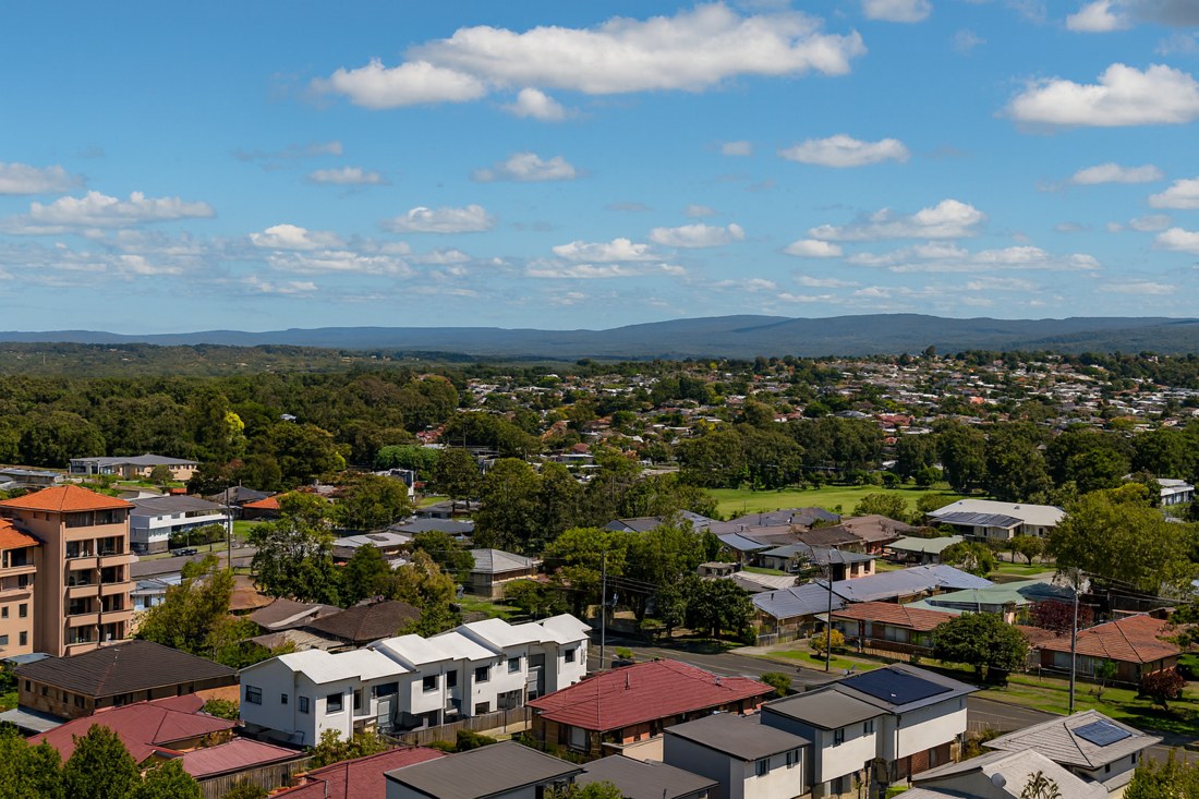 Edgeworth, NSW, Residential area with houses and distant hills