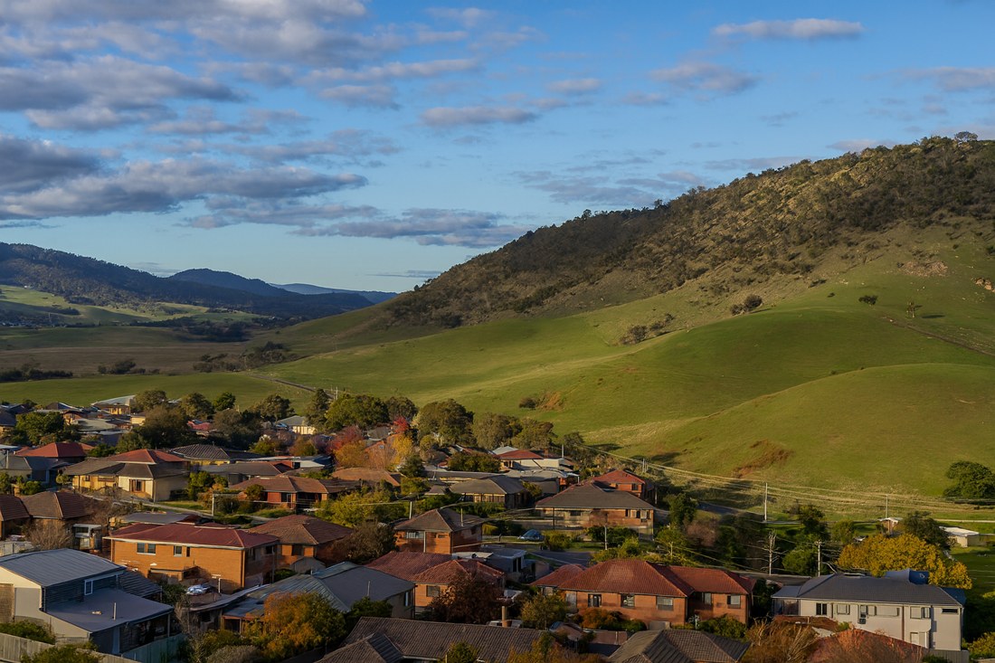 Elderslie, NSW, Residential area with hillside and scattered clouds