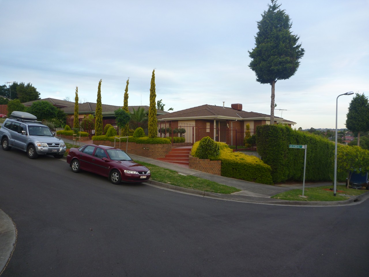 Endeavour Hills, VIC, Suburban street with brick house and garden
