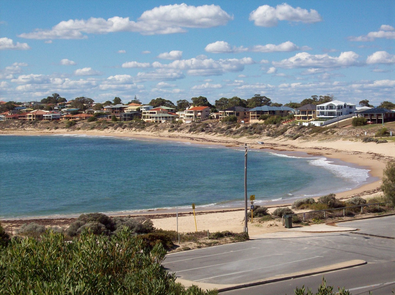 Falcon, WA, Houses overlooking a sandy beach with vegetation