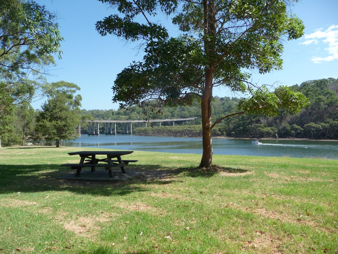 Forestville, NSW, Park bench near water with distant bridge