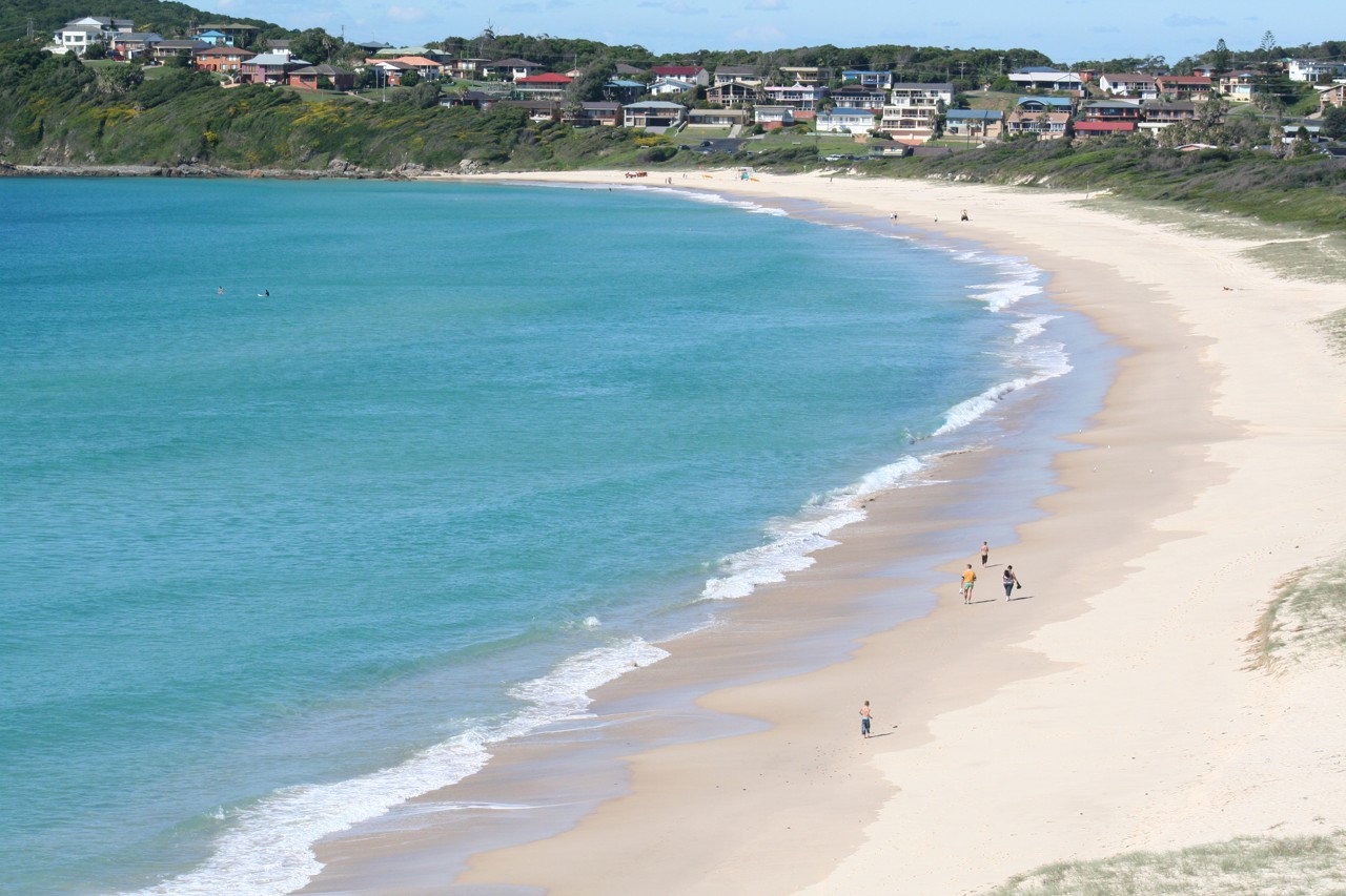 Forster, NSW, Curving coastline with sandy beach and houses