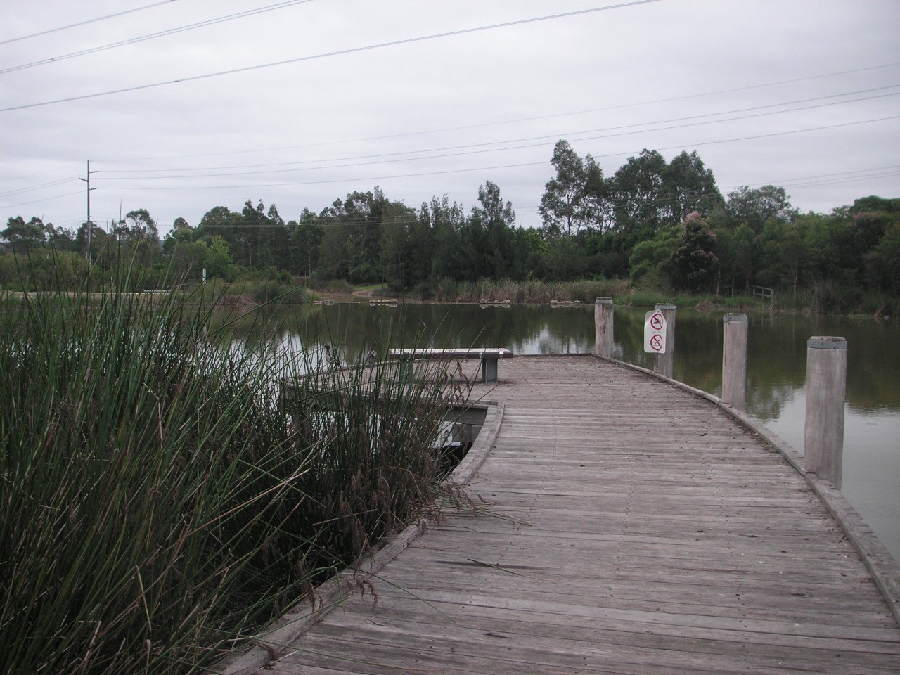Glenmore Park, NSW, Wooden boardwalk beside a small lake