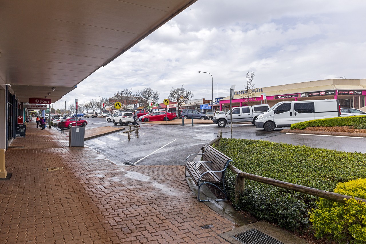Kurri Kurri, NSW, Shopping centre with parked vehicles and benches