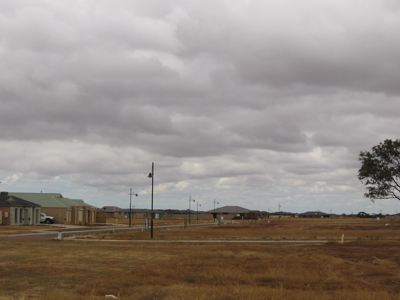 Kurunjang, VIC, Residential street with vacant lots and homes
