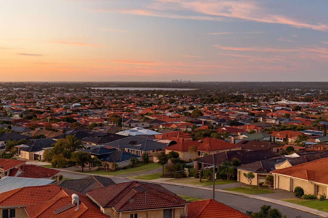 Landsdale, WA, View of red-tiled suburban rooftops at sunset