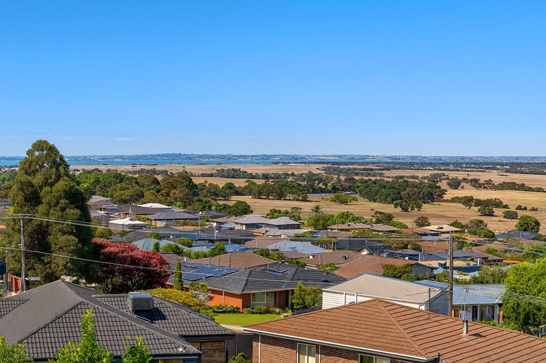 Leopold, VIC, Residential rooftops with distant countryside hills