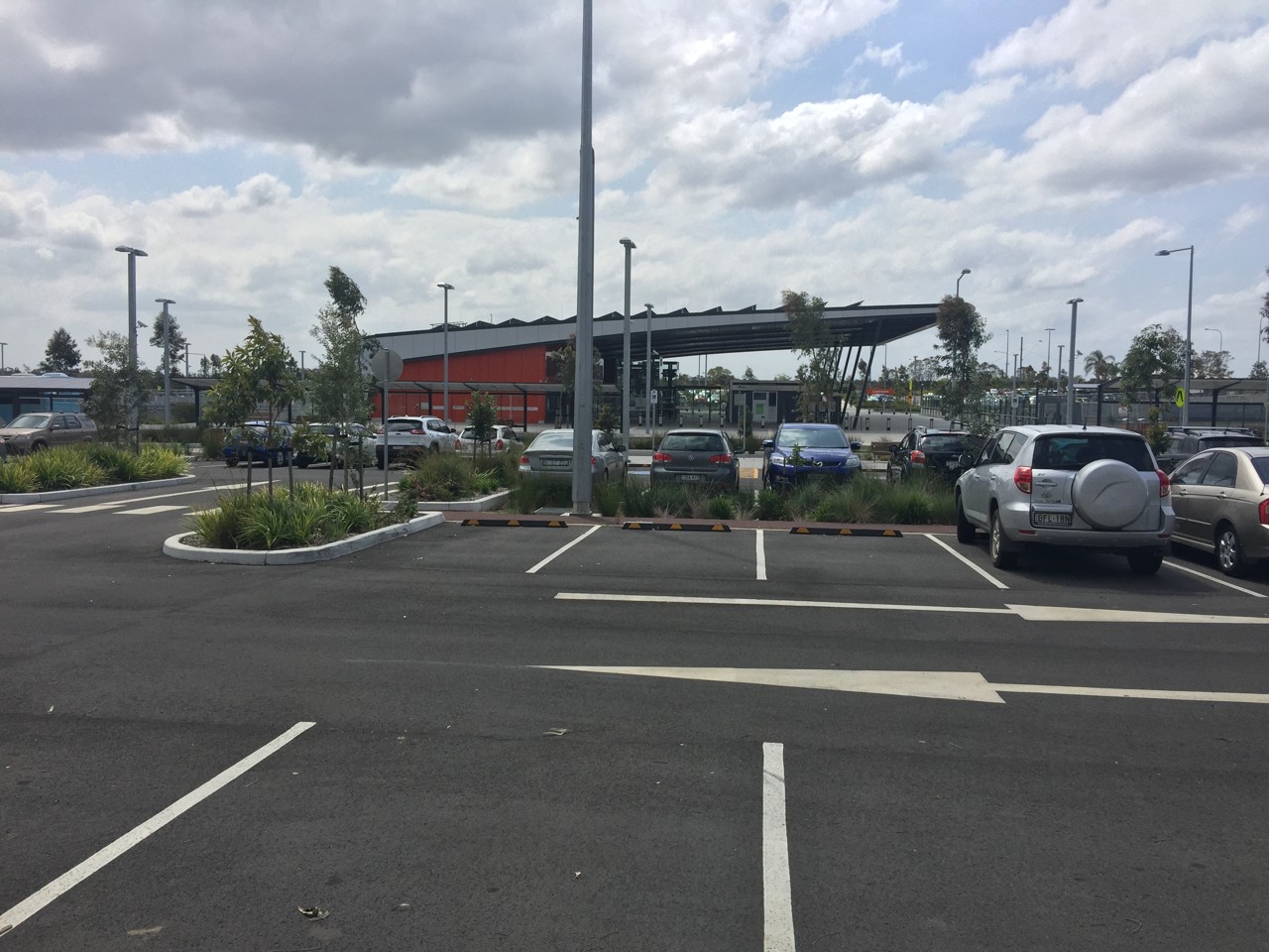 Leppington, NSW, Empty parking lot with parked cars and trees