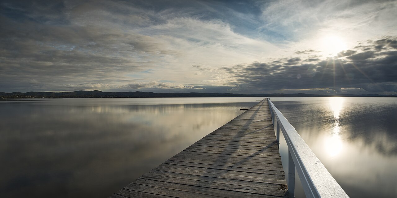 Long Jetty, NSW, Long wooden jetty extending over calm water