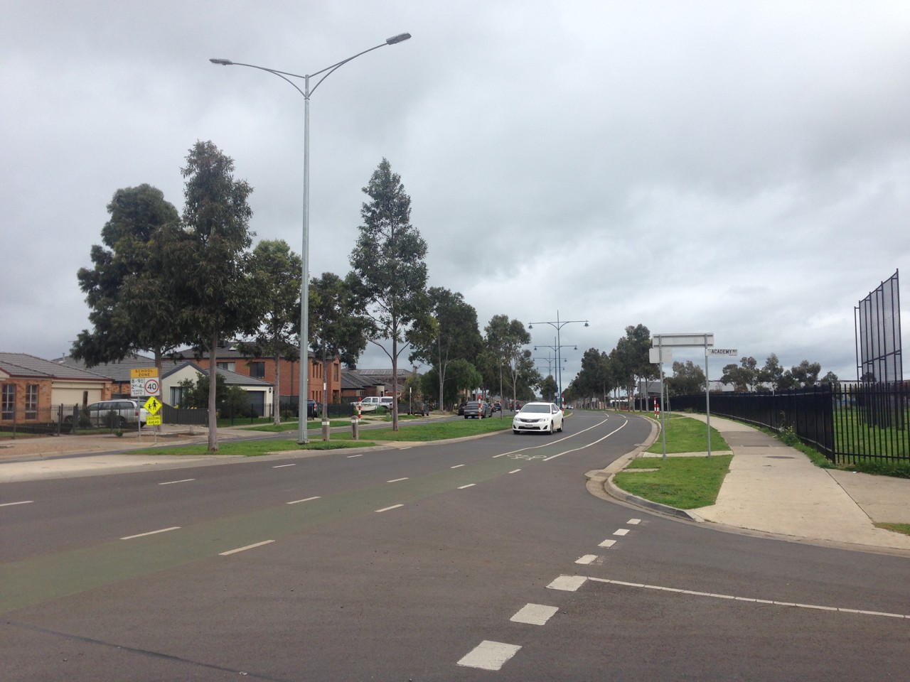 Manor Lakes, VIC, Residential street with cars and footpath