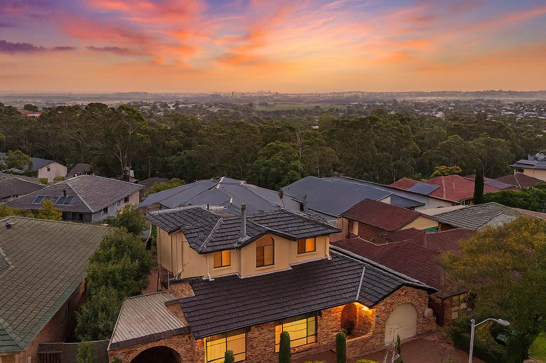 Maryland, NSW, Suburban houses with trees and sunset sky