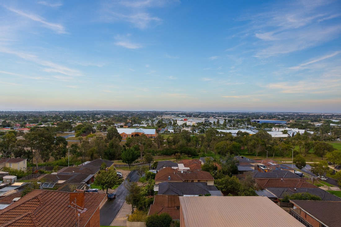 Melton West, VIC, Residential rooftops with distant industrial area view