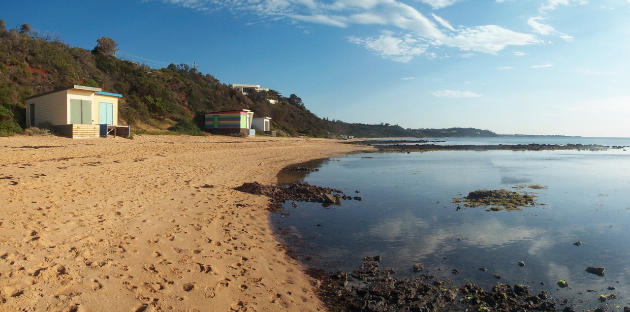 Mount Eliza, VIC, Beachfront with bathing boxes and rocky shoreline