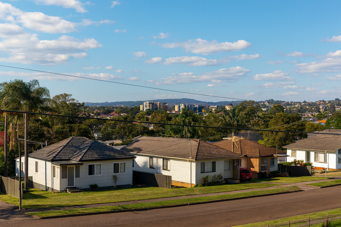 Mount Pritchard, NSW, Residential houses with distant city skyline