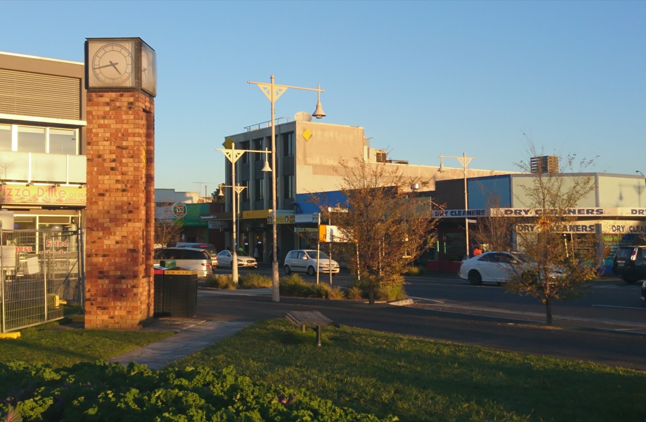 Noble Park, VIC, Clock tower and shops on a street corner