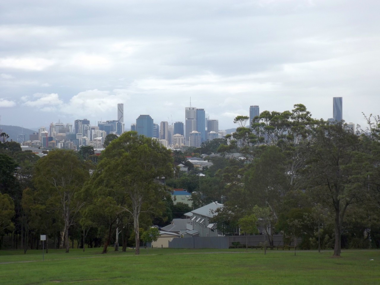 Norman Park, QLD, Distant city skyline beyond a grassy park
