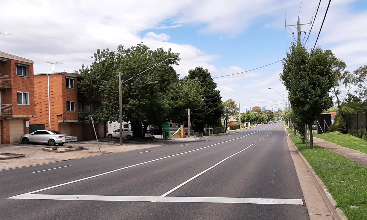 Oak Park, VIC, Wide suburban street with apartment buildings