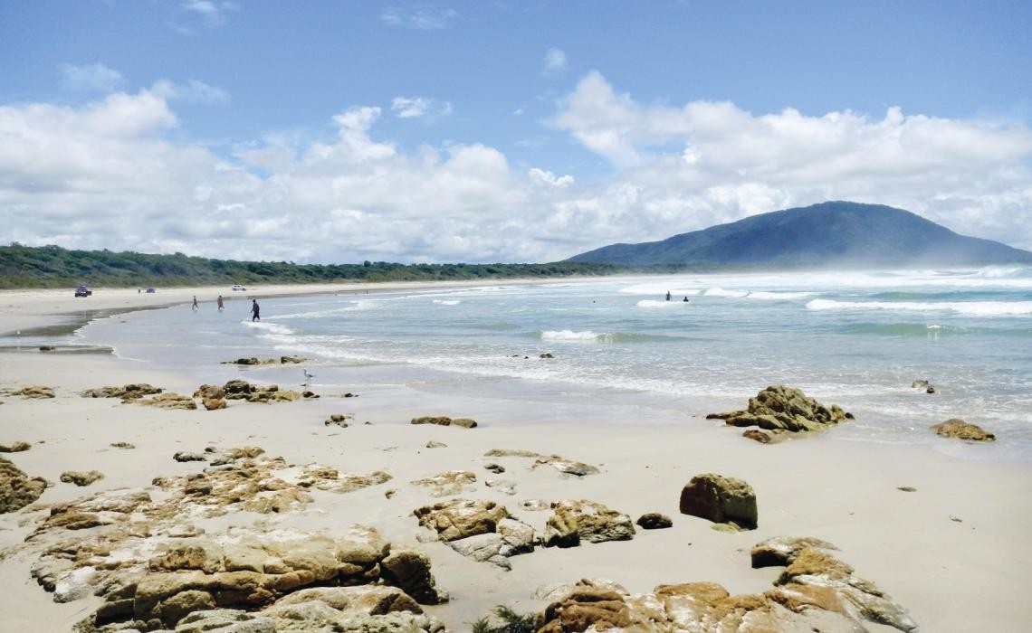 Old Bar, NSW, Waves crashing on sandy beach with distant headland