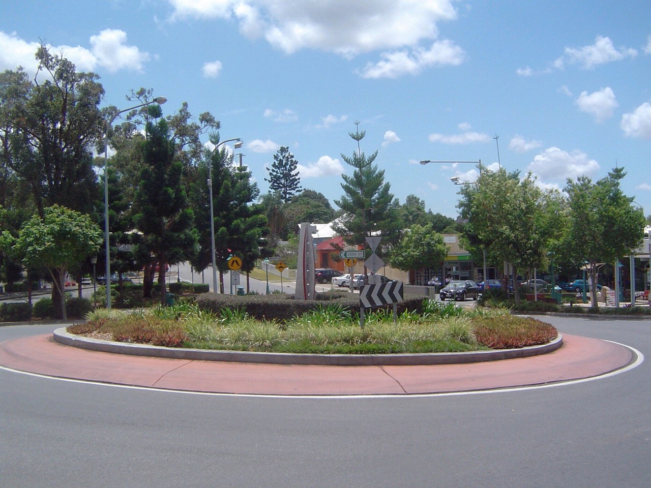 Oxley, QLD, Roundabout with trees and directional sign