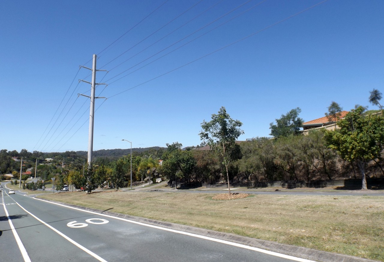 Pacific Pines, QLD, Roadside view with power lines and hills