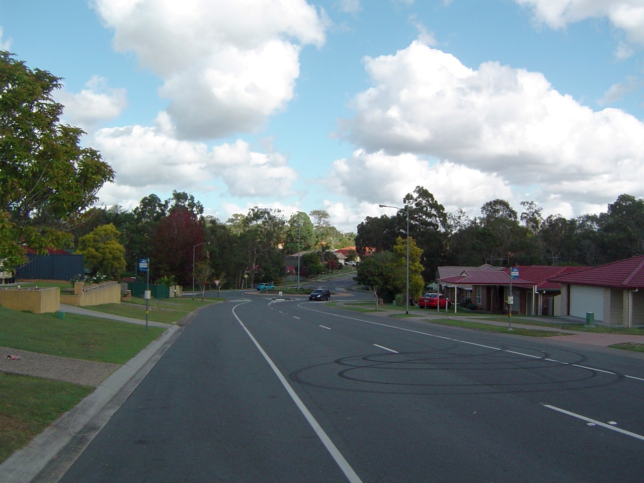 Regents Park, QLD, Curved suburban street with trees and houses