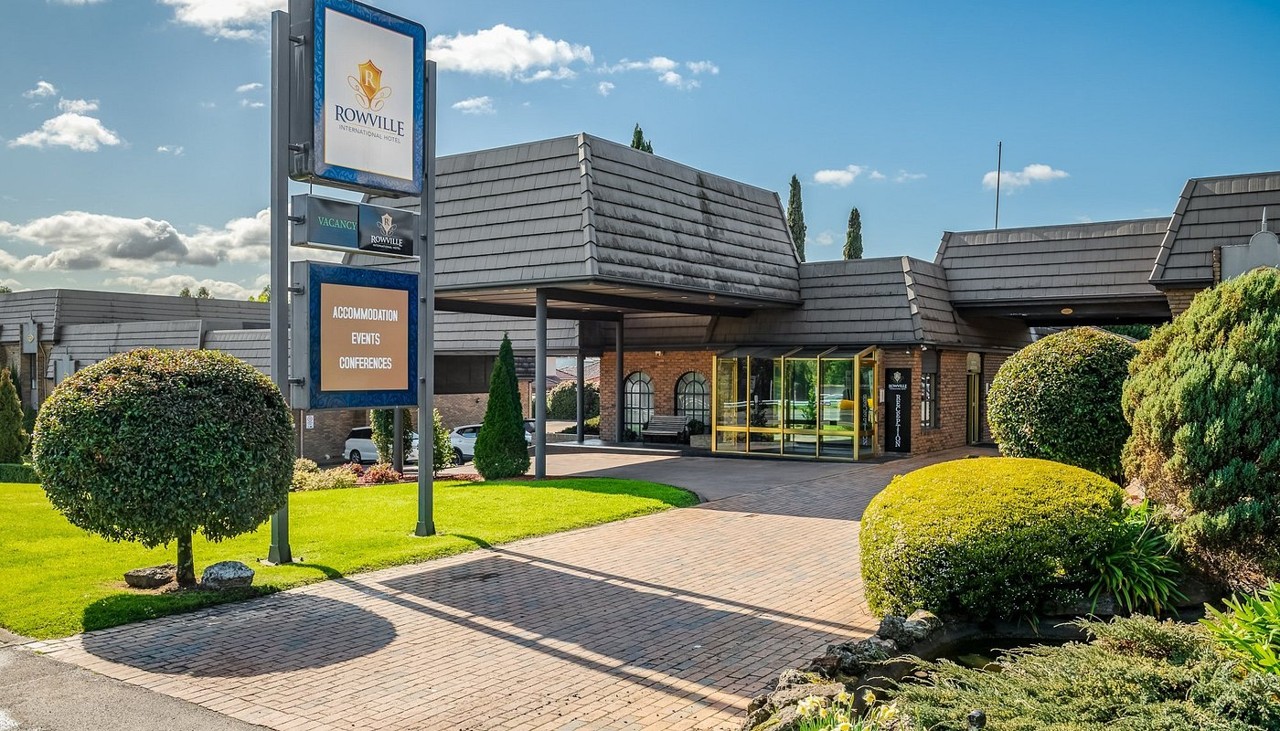 Rowville, VIC, Brick building with landscaped garden and sign