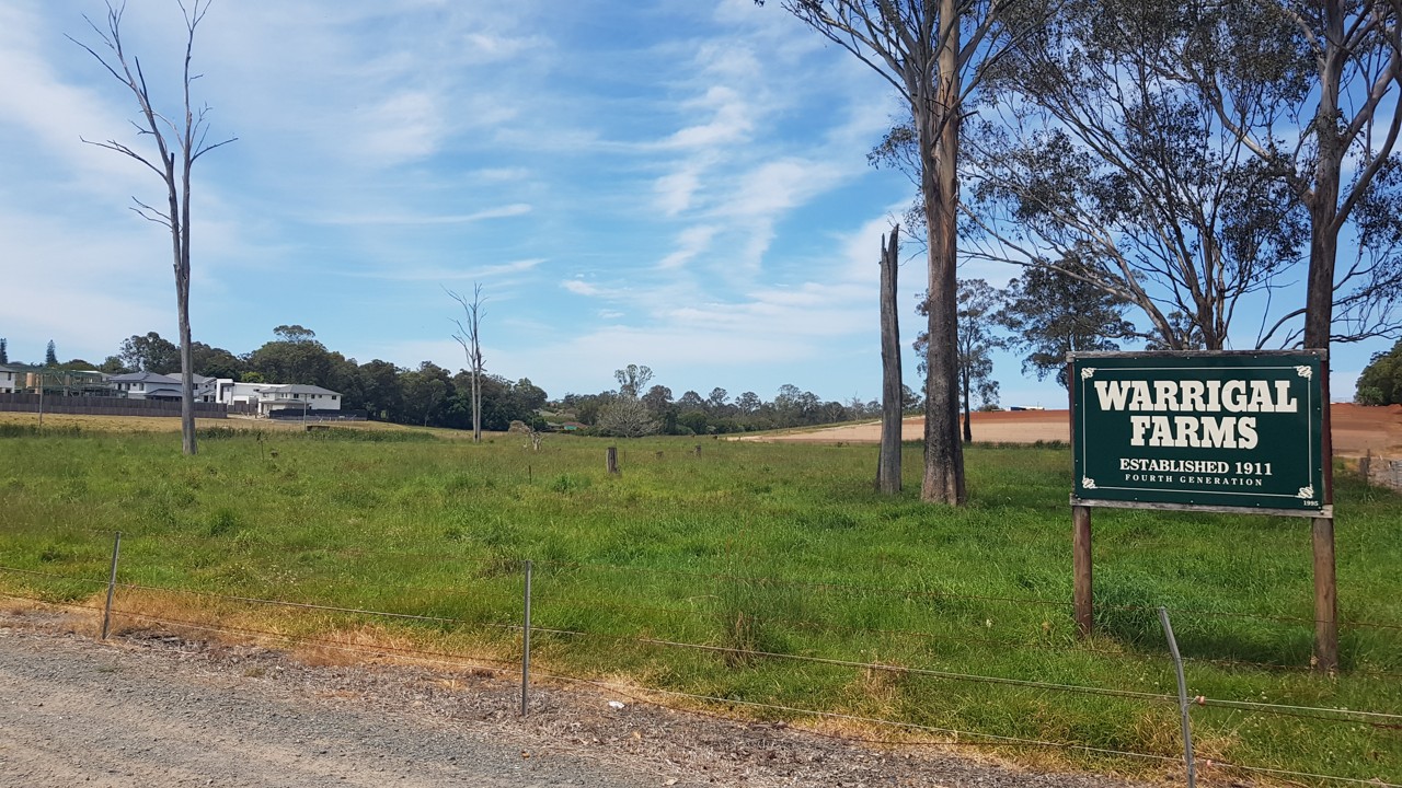 Runcorn, QLD, Entrance sign for Warrigal Farms with fields