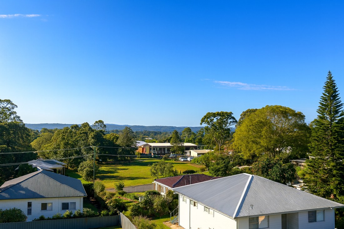 Russell Island, QLD — Houses with trees and distant hills