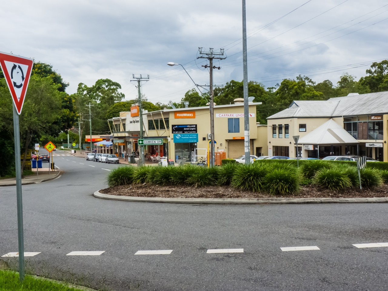 St Lucia, QLD, Shops and roundabout on a suburban street