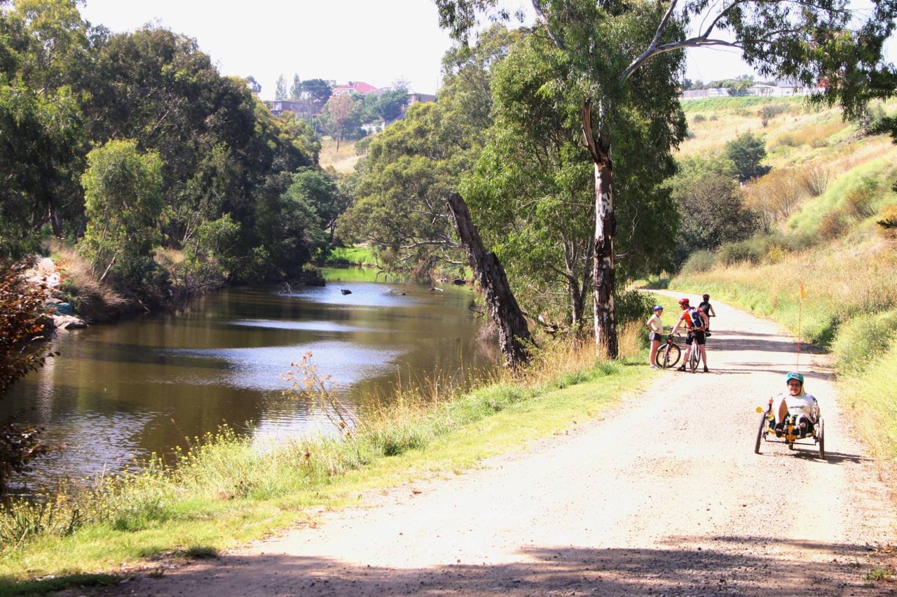 Sunshine North, VIC — Cyclists on a path by a river