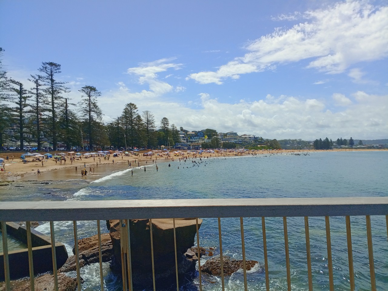 Terrigal, NSW, Beach with people, seen from a railing