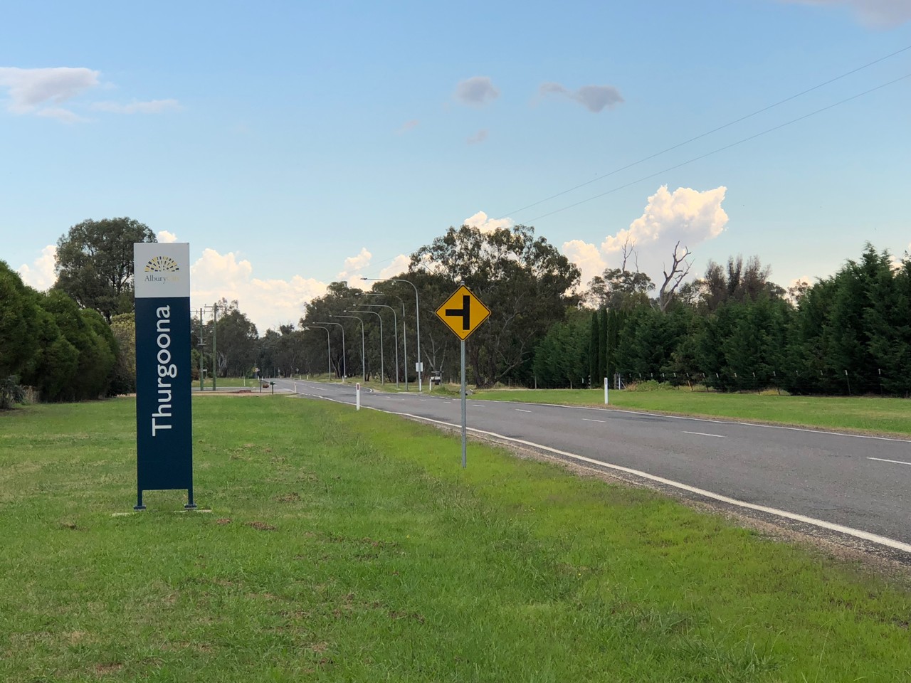 Thurgoona, NSW, Roadside sign and trees along a street